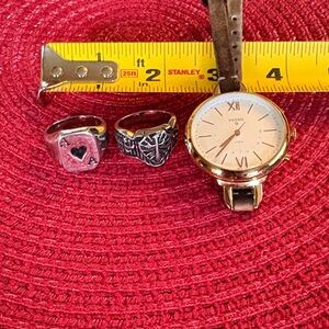 Assorted jewelry. Fossil Gold Watch with Brown Strap and Two Silver color rings